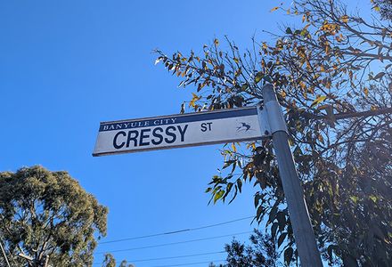 A sign for Cressy street street on a pole, providing navigational guidance in a suburban setting.