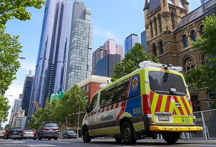 An Ambulance Victoria van driving through the streets of Melbourne.