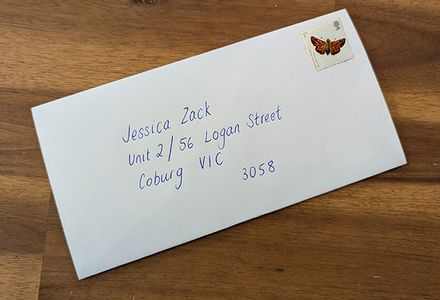 A white envelope with a stamp displaying an address for a person living in Melbourne, Victoria.