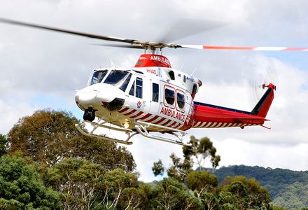 An Ambulance Victoria helicopter mid flight.
